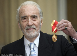 Cool-Dude-Bad-Ass-From-Birth Christopher Lee: World War II Secret Agent, Wizard, Jedi, Heavy Metal Singer, and all-around British Demi-God, holding the rare-but-Universally-acknowledged “I Rule You” Medal.